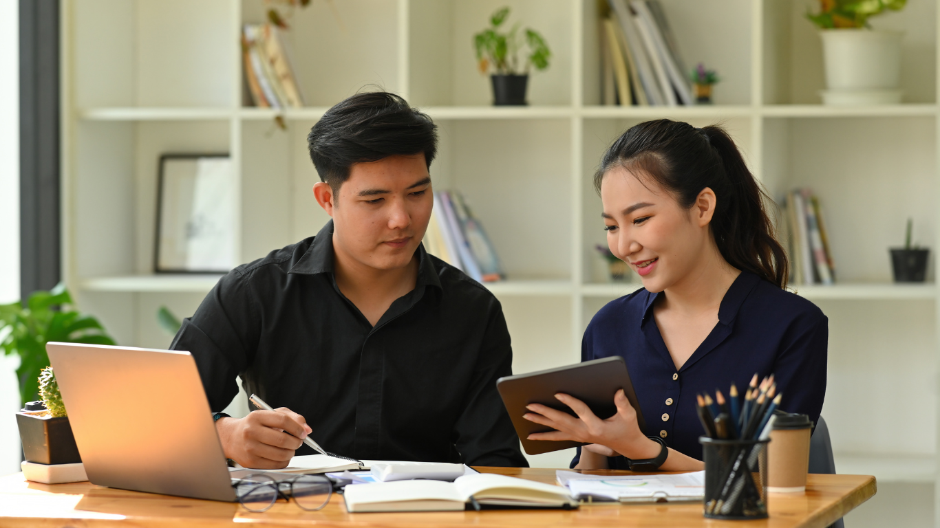 image of two people working together at a desk