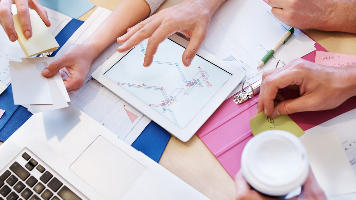 image of hands collaborating at a desk